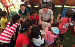 Jeffrey Kottler, top center, plays a game to soothe and distract children in the Empower Nepali Girls program.