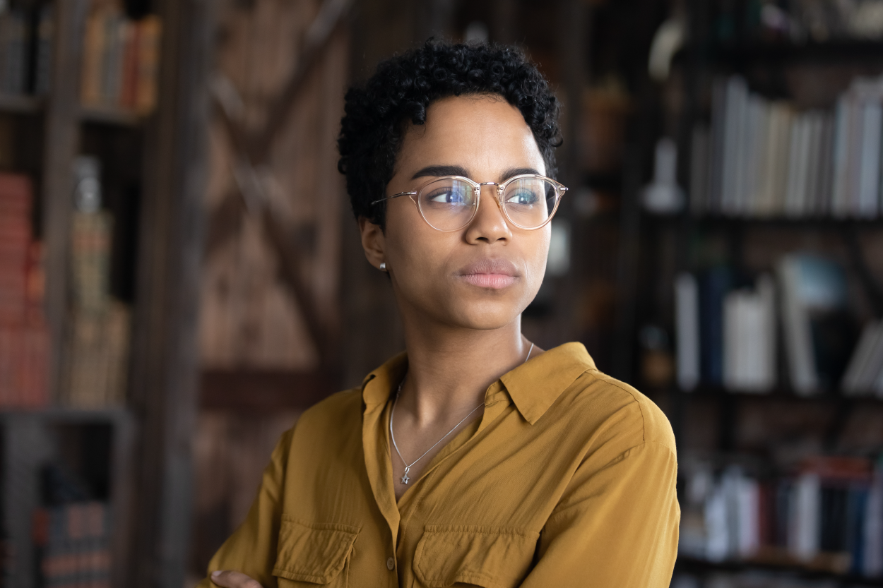 A close-up of a Black person staring off to the side