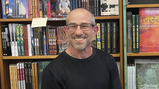 headshot of Rick Balkin in front of a books in a bookstore